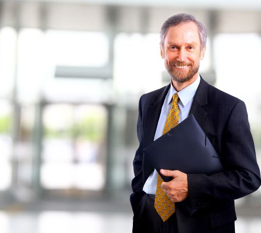 Over 50 in the Job Market - Older professional man holding portfolio