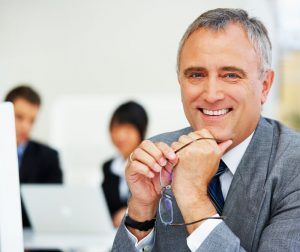 Relaunching-After-50-older-business-man-holding-glasses-300x252